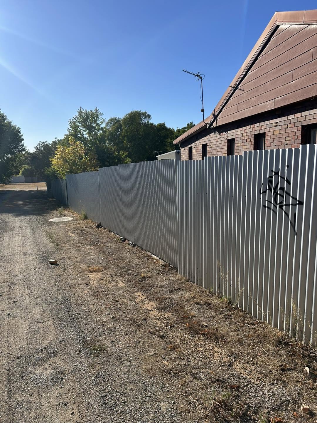 A new Colorbond fence beside a brick home – a real job by Anesbury Fencing & Construction in Wagga Wagga
