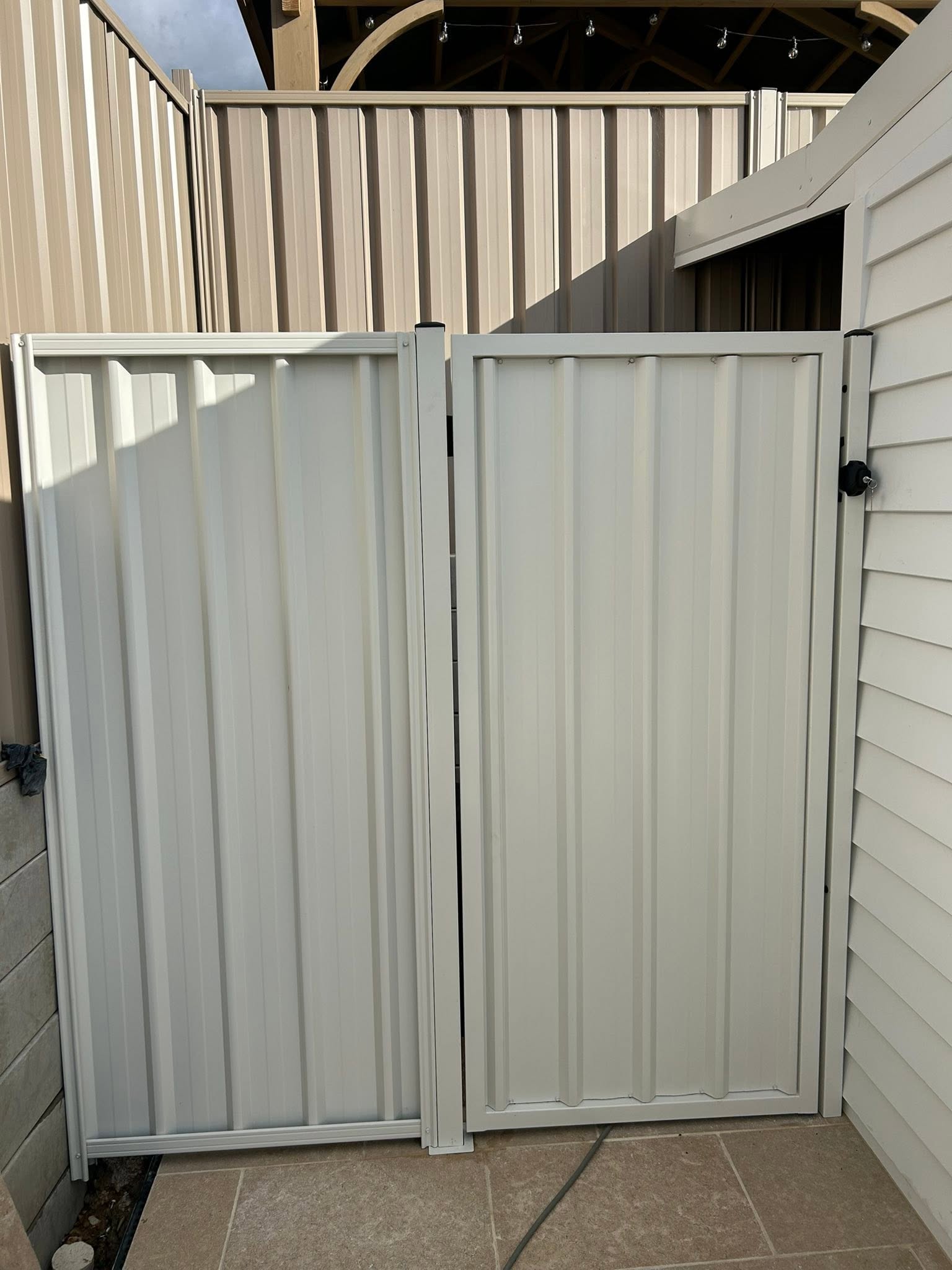 A neat cream Colorbond gate installed by Anesbury Fencing & Construction