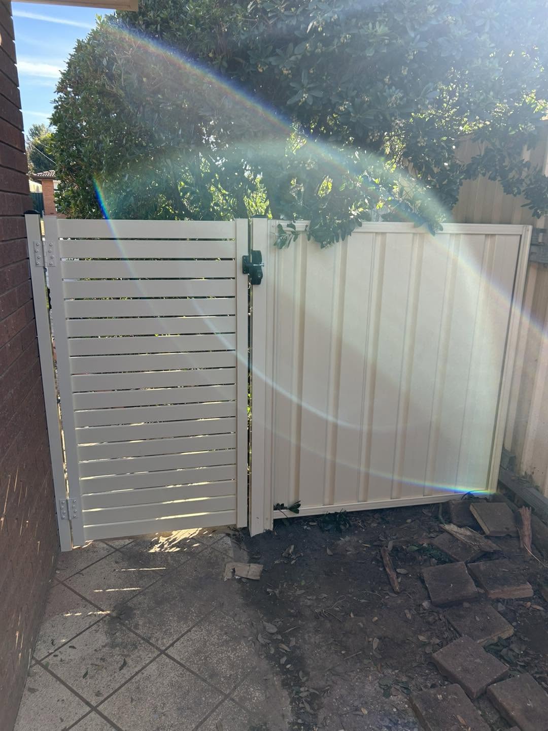A white slat gate in afternoon light – a real job by Anesbury Fencing & Construction in Wagga Wagga