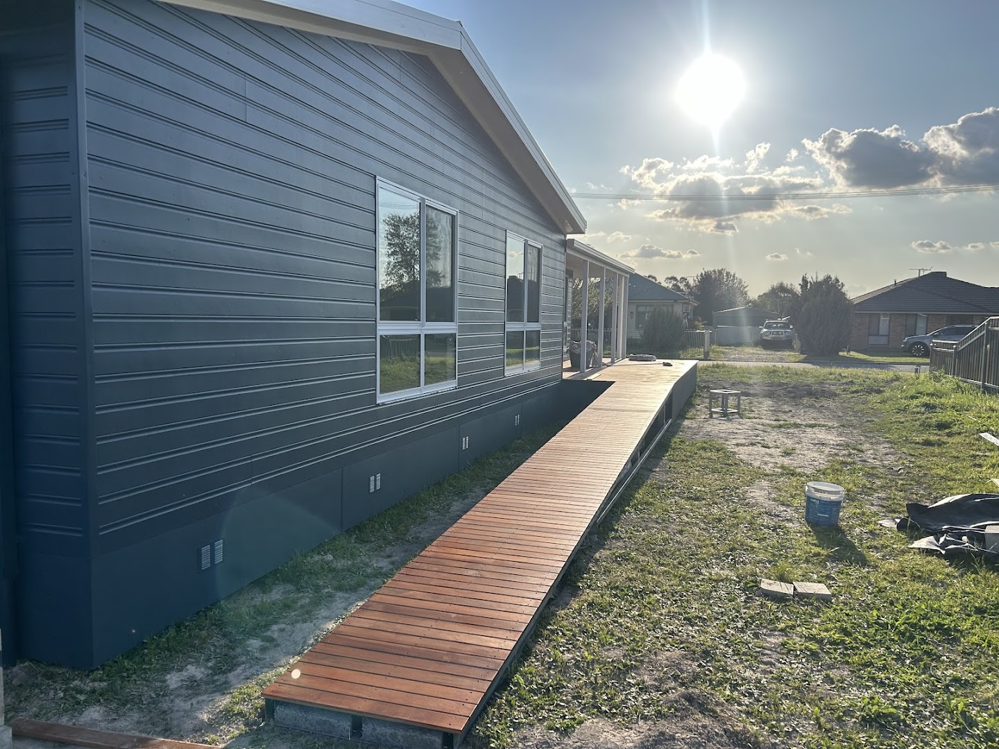 A Colorbond fence and new timber deck along a home – a real job by Anesbury Fencing & Construction in Wagga Wagga