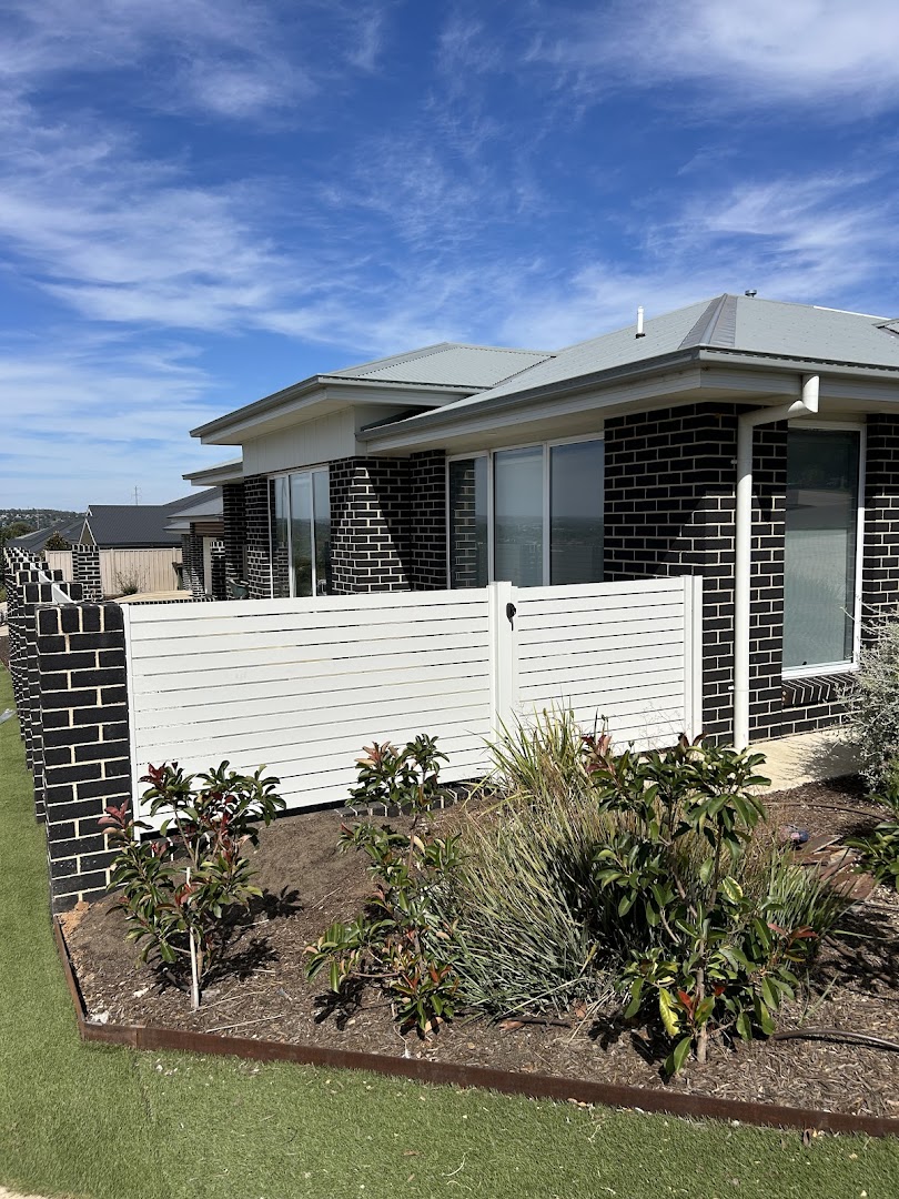 A white slat privacy wall and fresh garden bed at a Wagga Wagga home, built by Anesbury Fencing